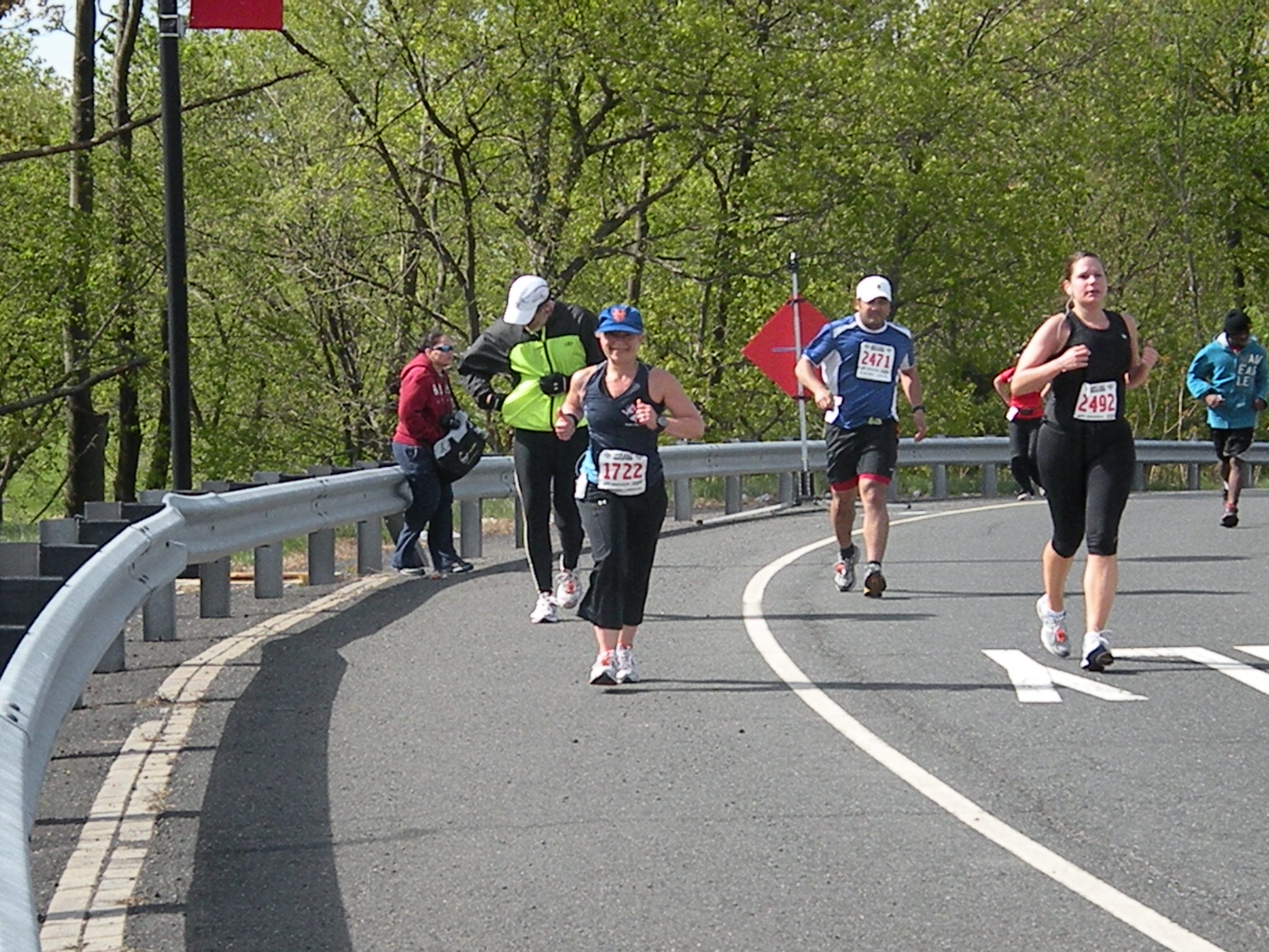 several people are running over a road with banners