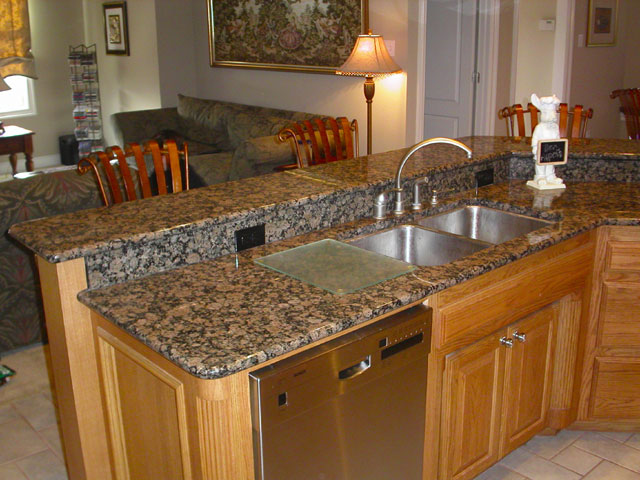 a home kitchen with an oven, a sink and dishwasher