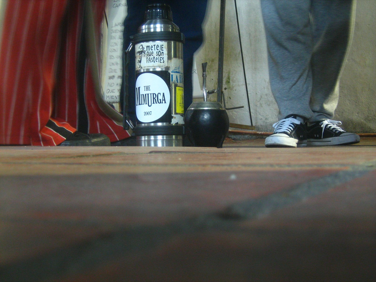 a person standing on the wooden floor with a bottle