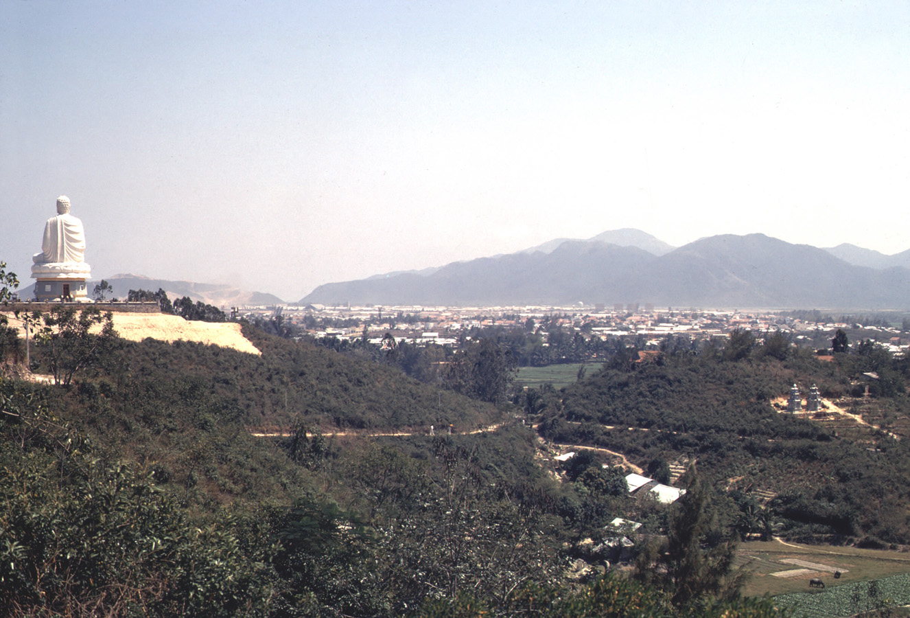 an aerial view of a landscape with mountains in the background