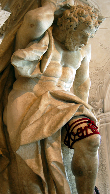the stone statue is wearing red and white socks