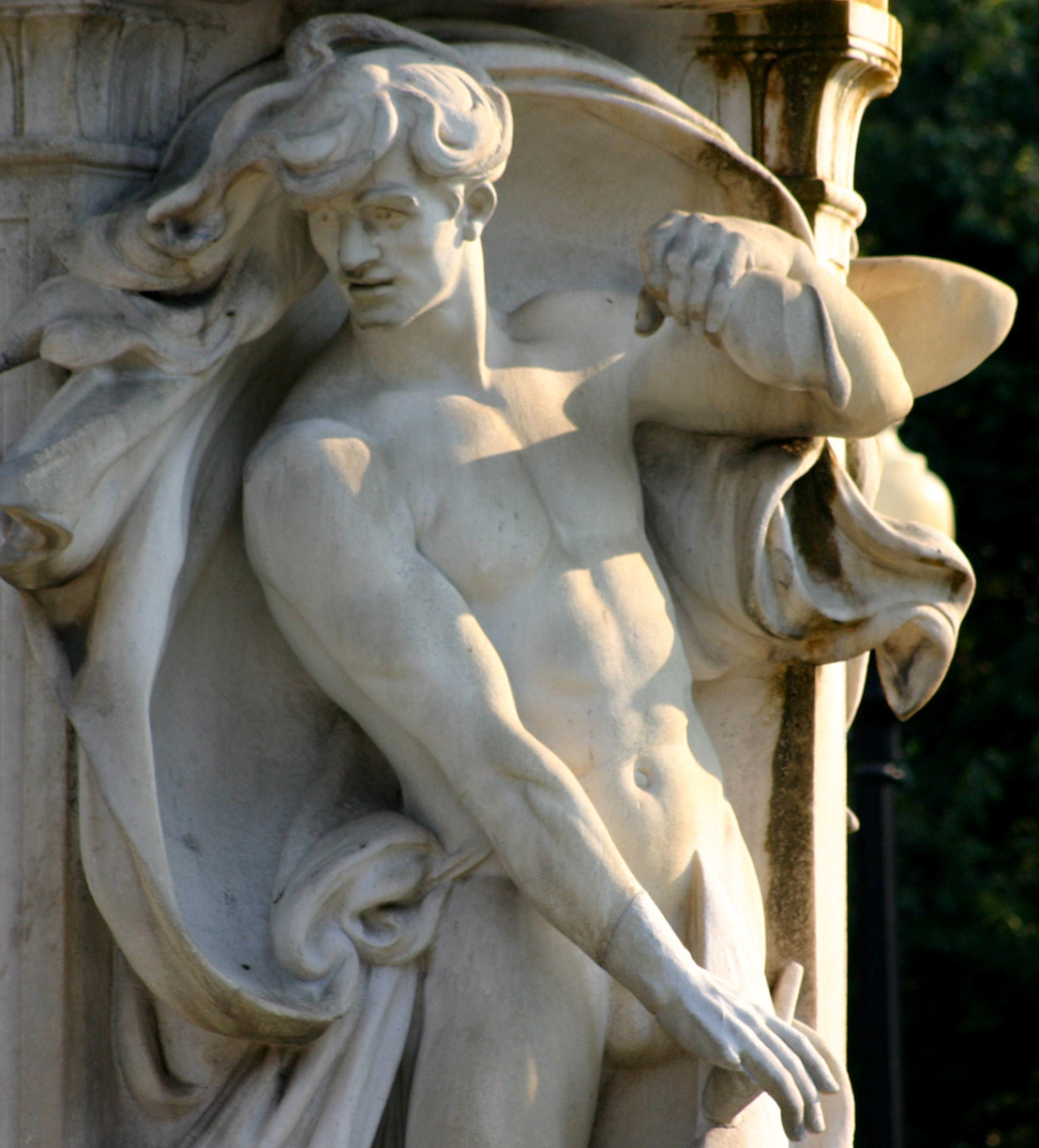a marble statue of an  man holding a bird