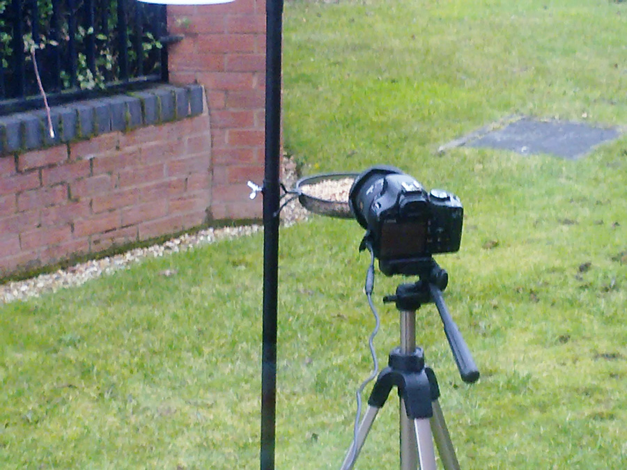 an electronic device on top of a tripod outdoors