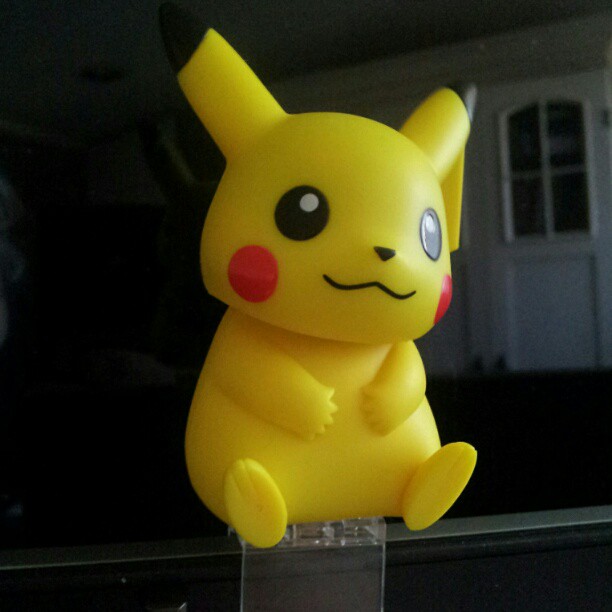 a pikachu sitting inside a clear box