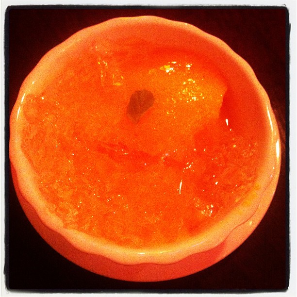a bright orange bowl filled with water and other items