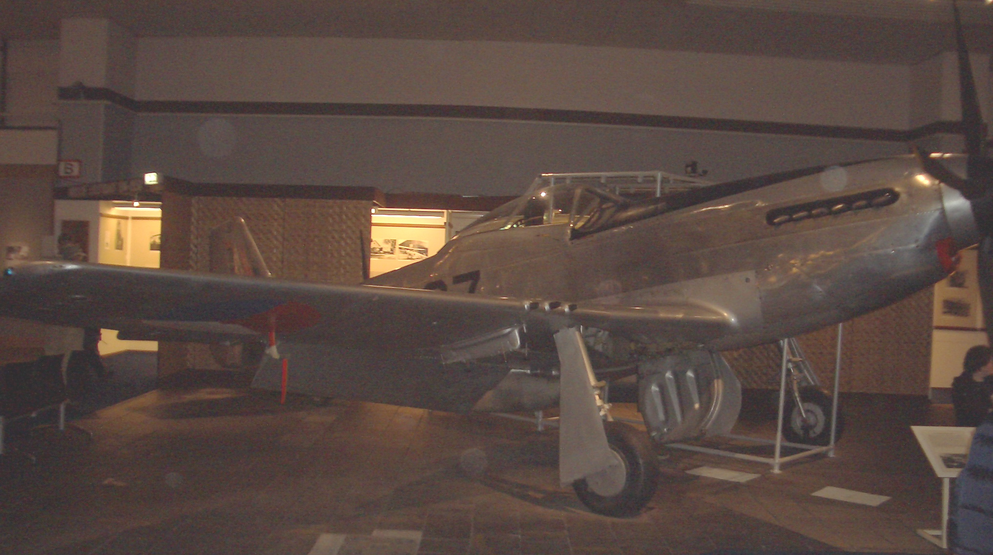 a plane in a museum that is grey and white