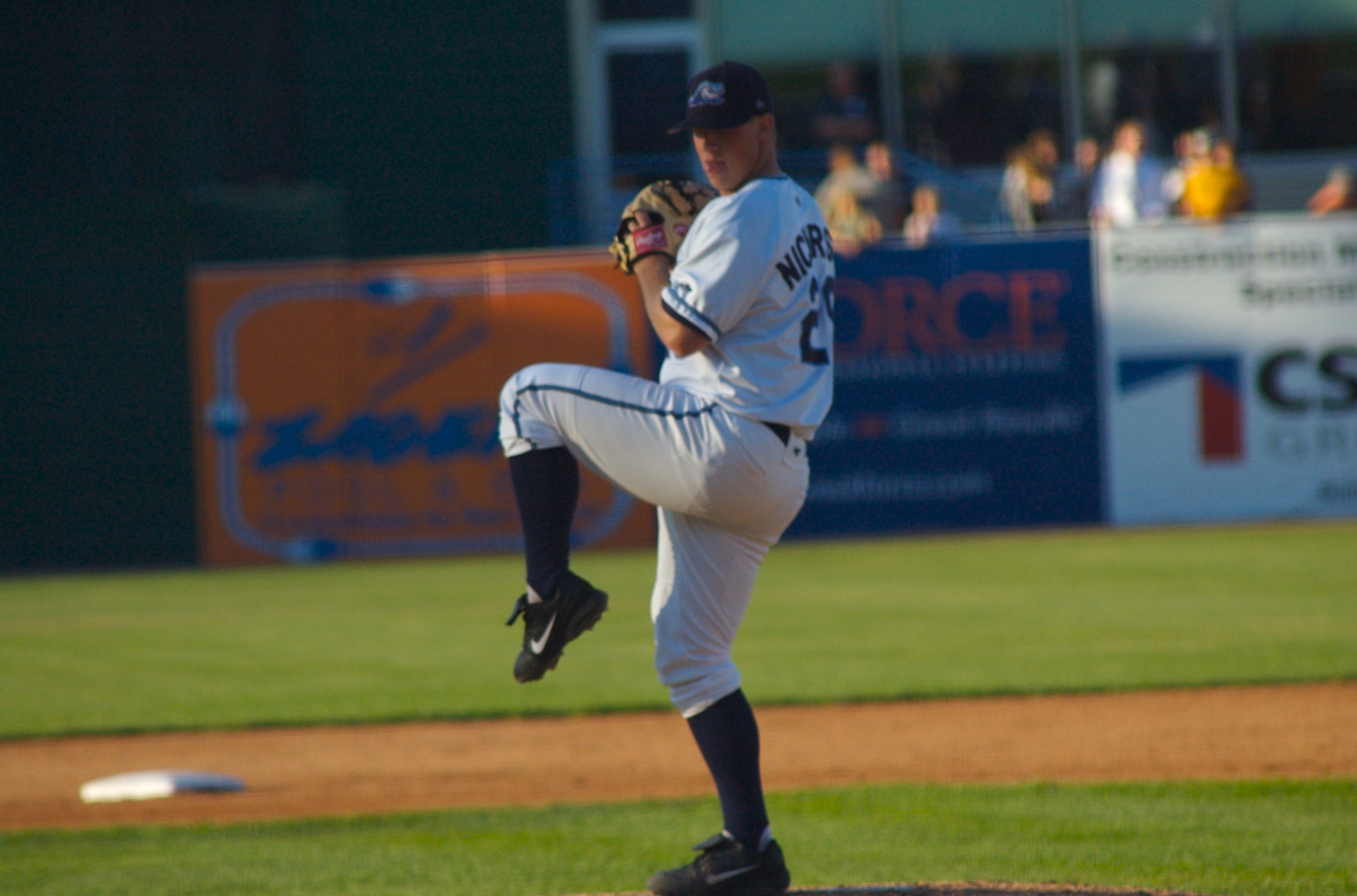 a pitcher winds up to throw a baseball