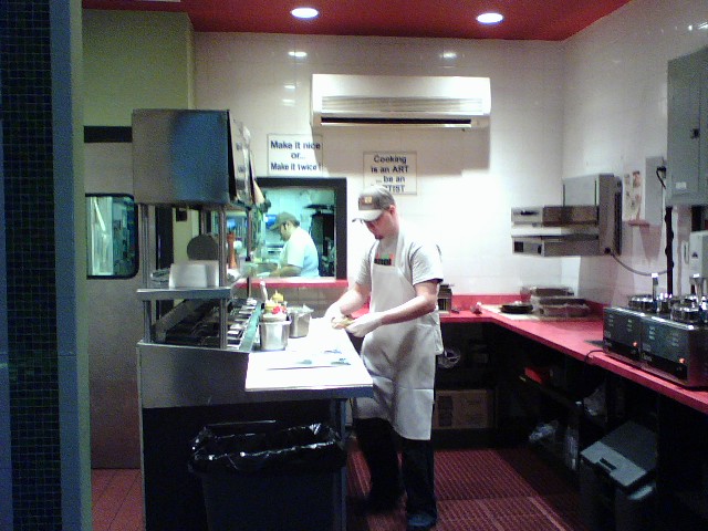 there is a chef preparing food in the kitchen