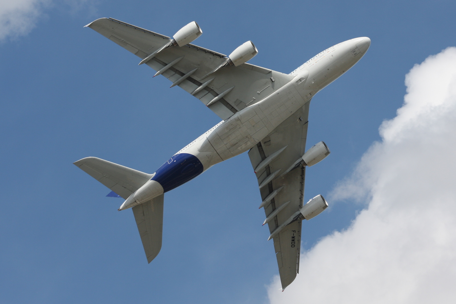 an airplane is flying against the blue sky