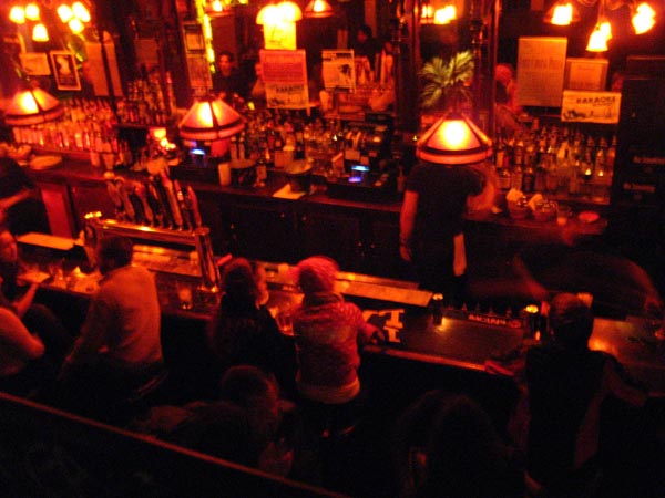 a bar with many people sitting at it