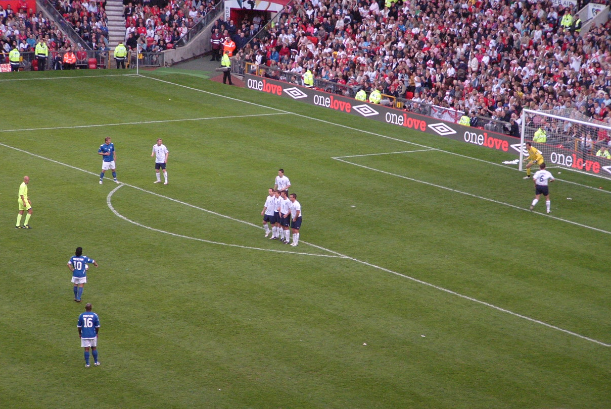 soccer team of players on field playing in large crowd