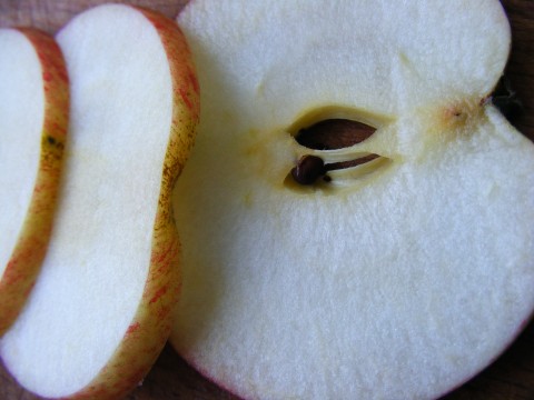 apple sliced up and ready to eat on a  board
