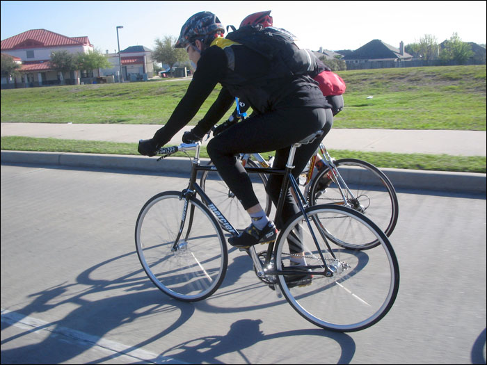 a person riding a bike on a city street