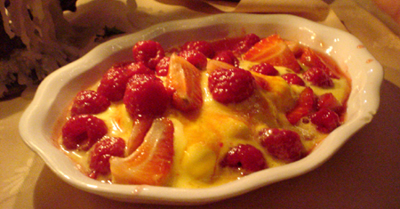 a white bowl filled with some food next to a person