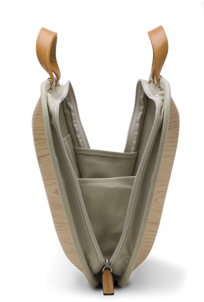 an empty beige and tan bag with the bottom open