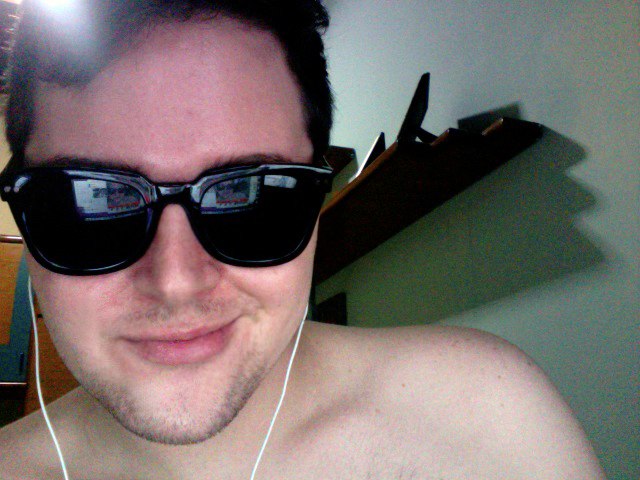 a man with  wearing sunglasses and headphones