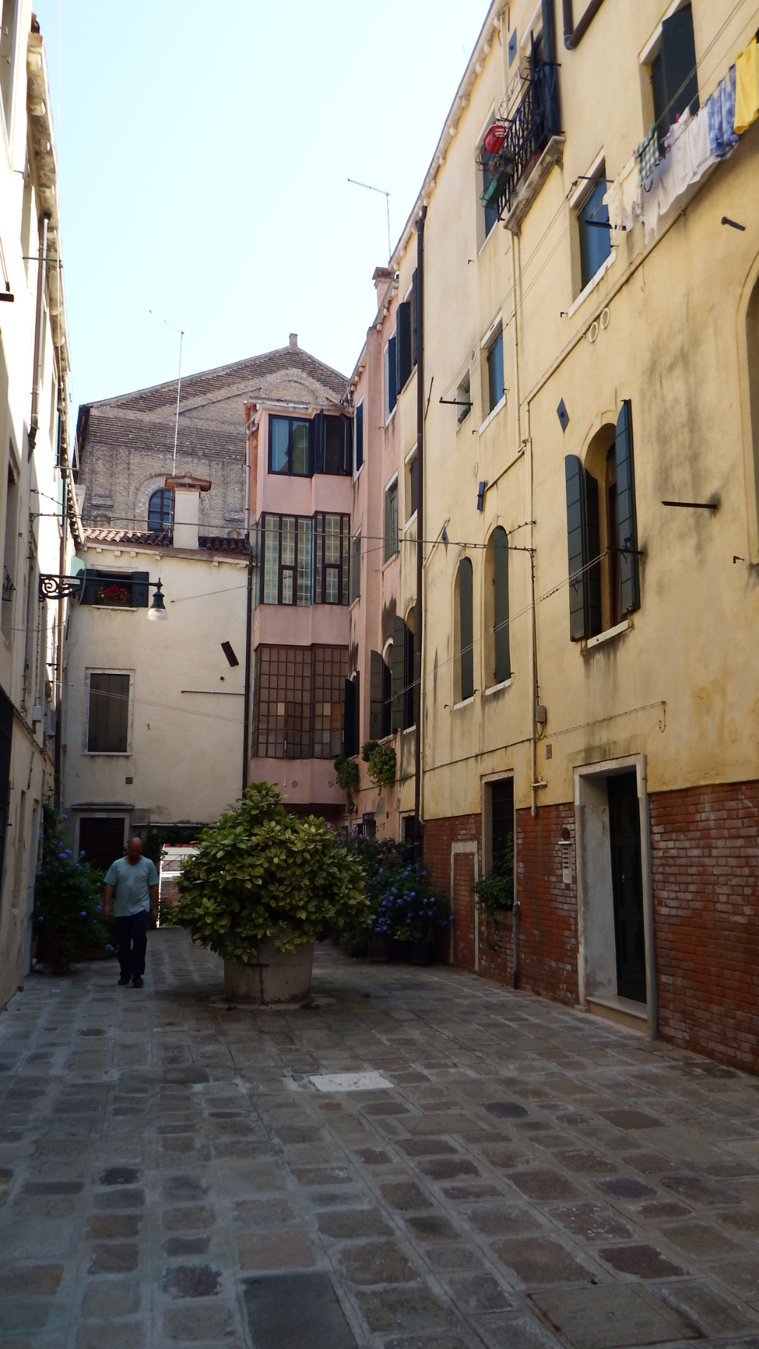 two people walk in the alley between some buildings