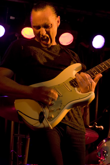 a man is playing a guitar on stage