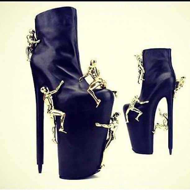 the high - heeled shoes have skeleton chains attached to them