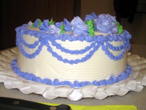 an image of a large white and blue cake on a table