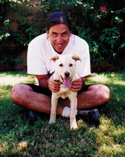 a man is posing for a picture with his dog