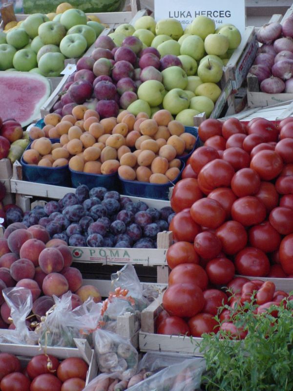 an assortment of fruit on display at a farmers market