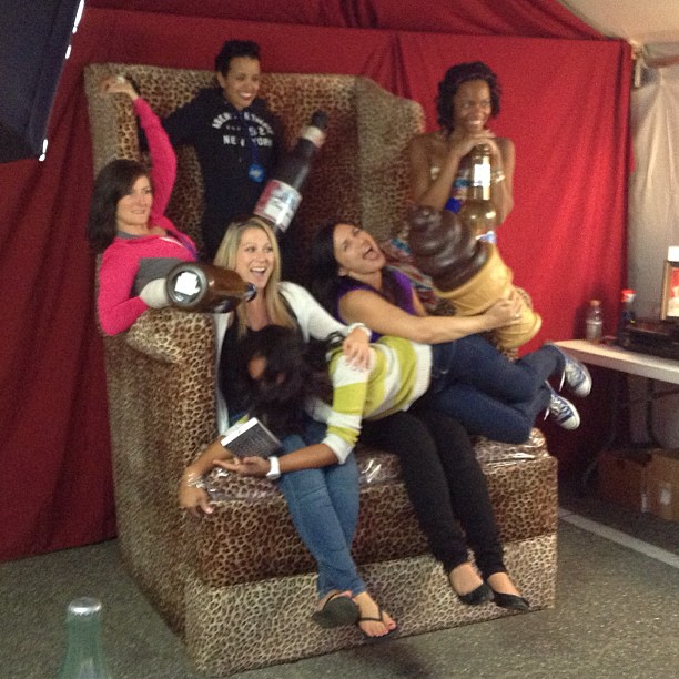 nine women sit in a chair posing for a po