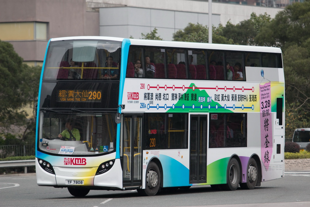 there is a white bus with two story on the street