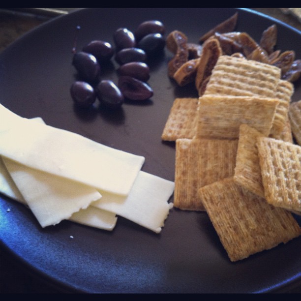 ers, olives and cheese in a plate