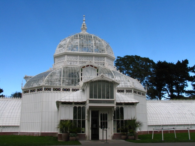 the entrance to the glasshouse is flanked by greenery