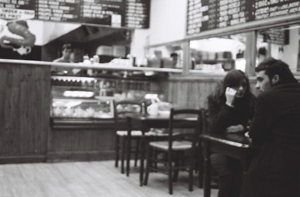 the man and woman are sitting at the tables