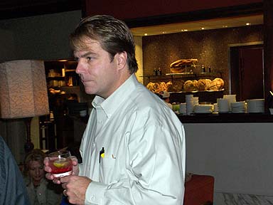 a man holding a glass full of some liquid