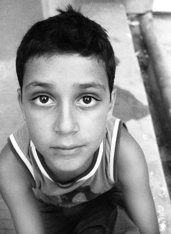 a black and white po of a boy with very big eyes