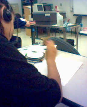 a person sitting at a desk with headphones on