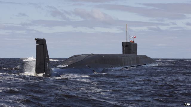 a blue nuclear submarine in the middle of water