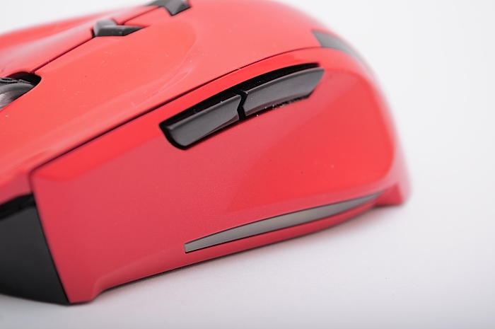 a red wireless mouse sitting on a table