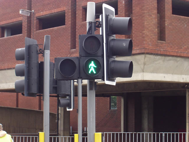 a pedestrian crossing signal is shown on a street corner