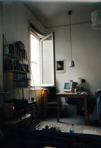 a cluttered bedroom with an old fashioned computer