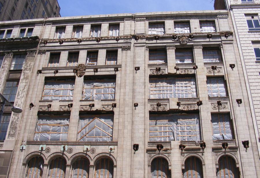 the corner of a grey two story building