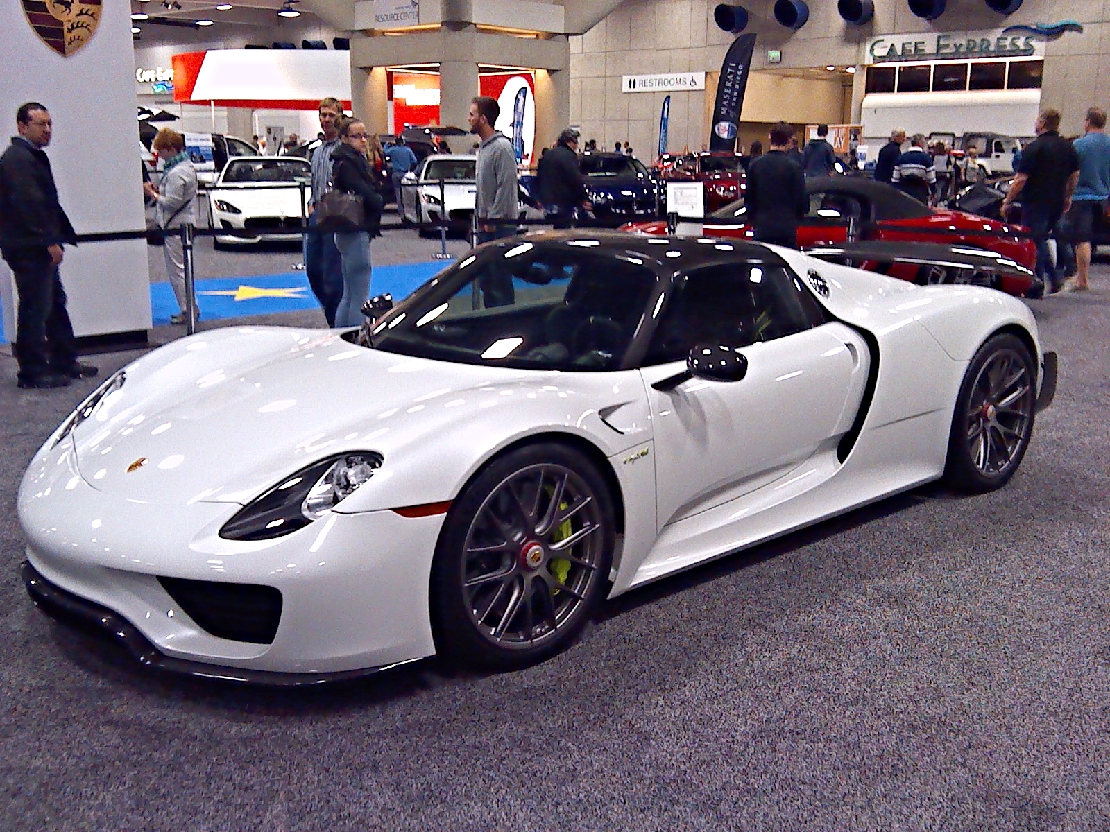 a white sports car at an auto show