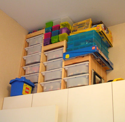 the shelves below the cabinet is full of bins