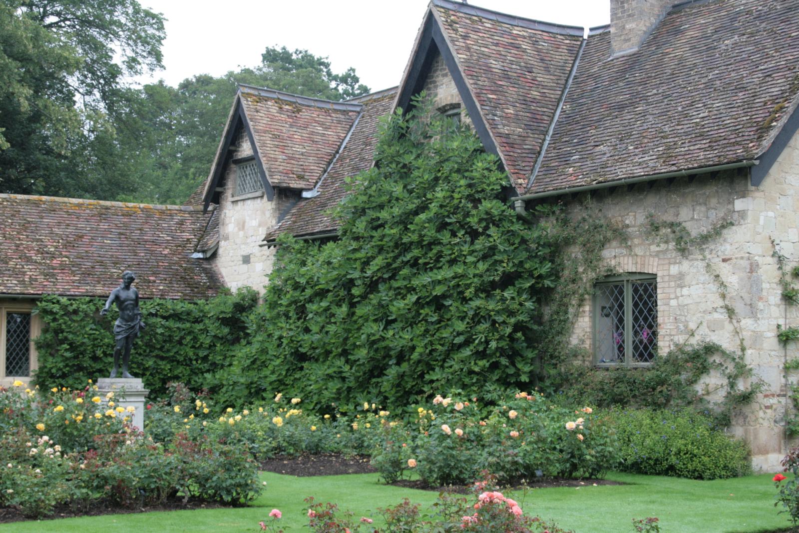 a home with an elegant garden and brick exterior