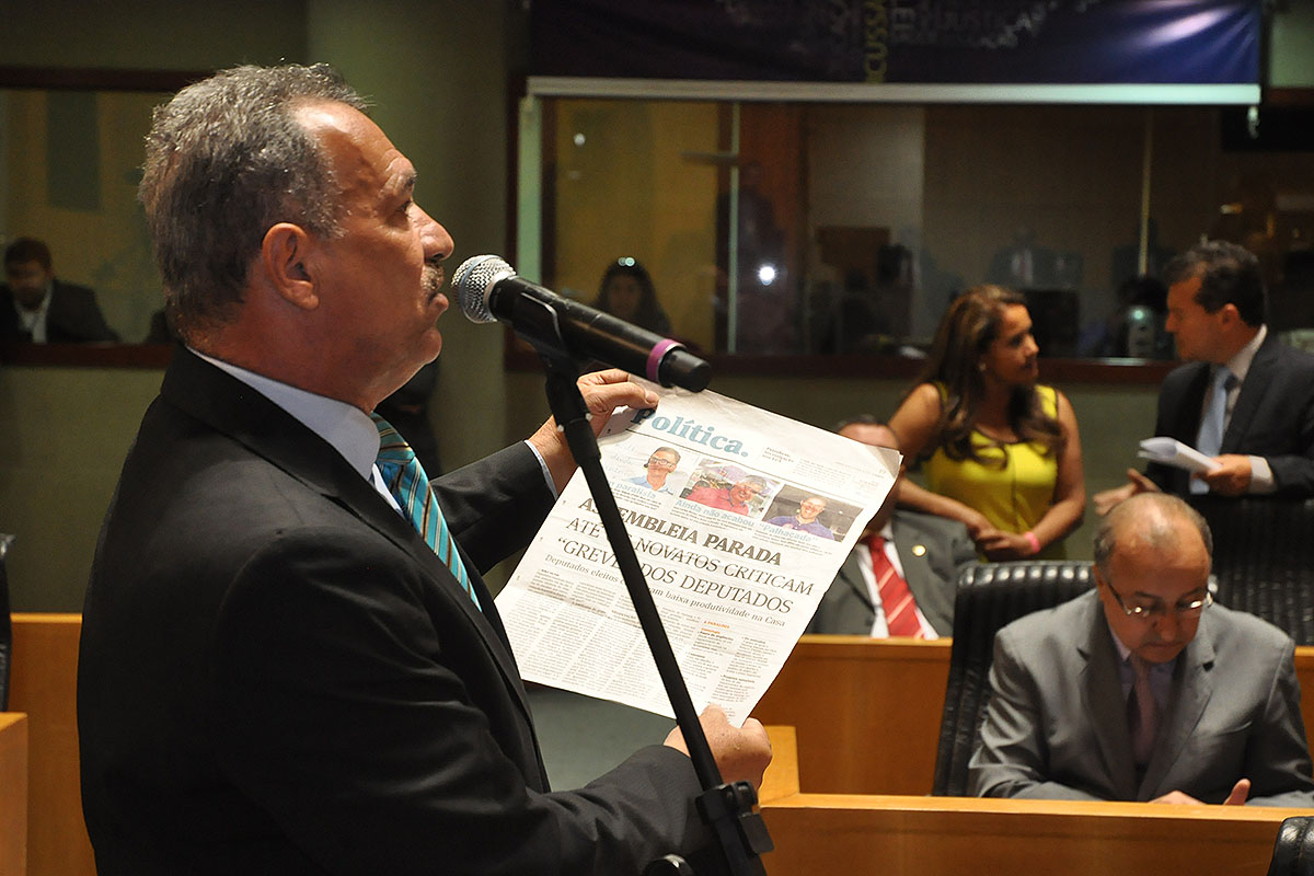 a man is reading the newspaper while standing at a podium