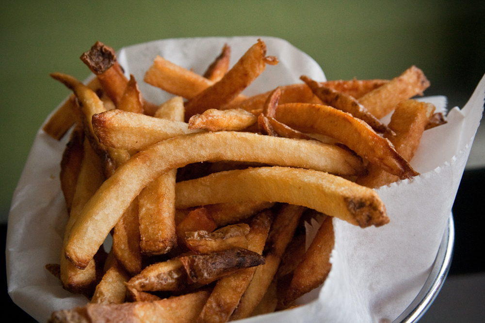 there is french fries in the basket on the table