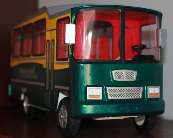 the plastic bus is green with red trims