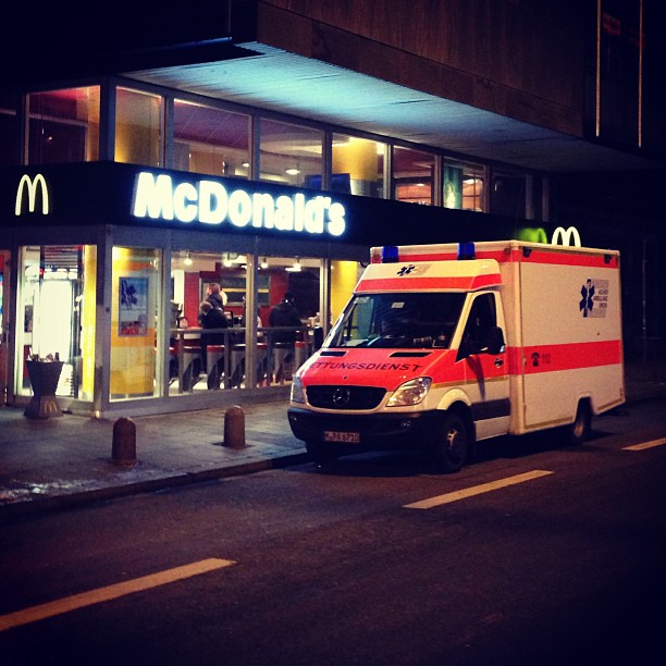 an ambulance is parked outside of a mcdonald's