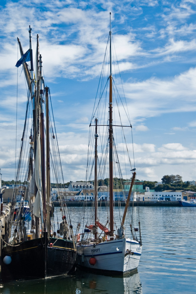 several boats are docked in the middle of a large body of water