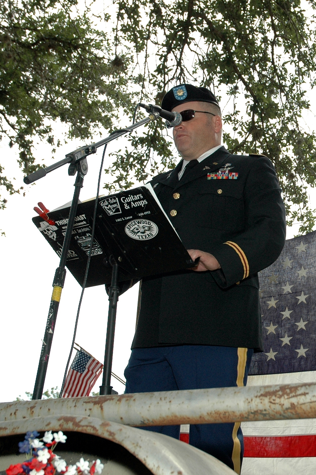 a man in military uniform is holding a microphone