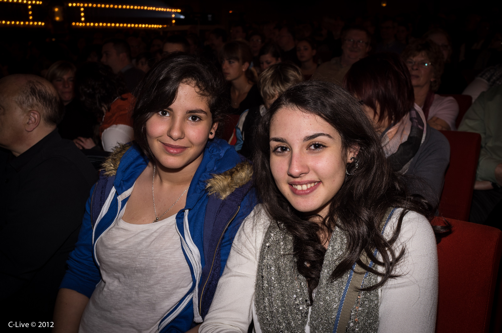 two girls in the audience at an event