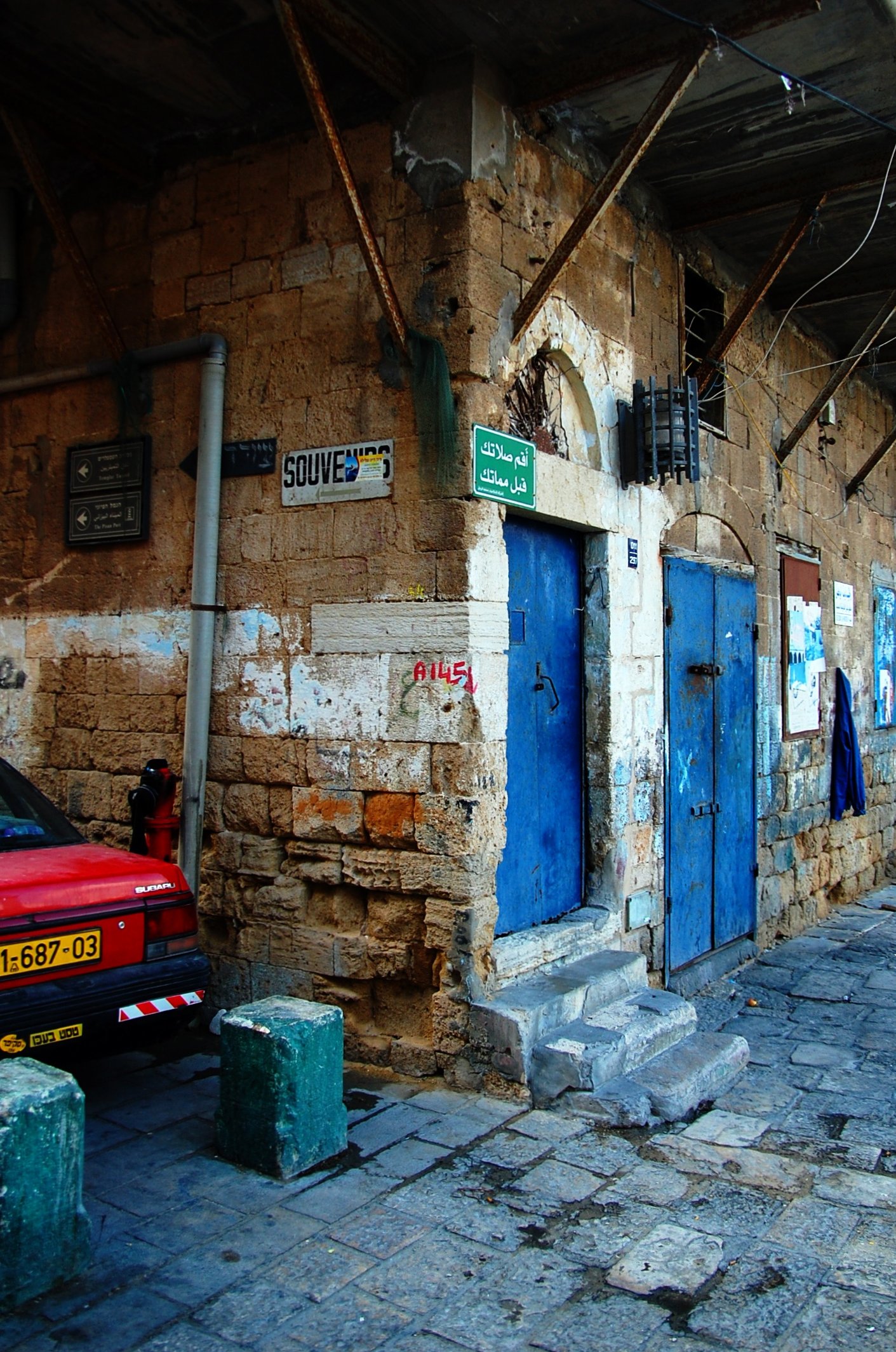 an old building with some blue doors on the side